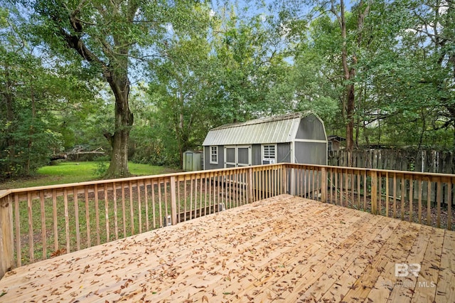 wooden deck with a yard and a storage unit