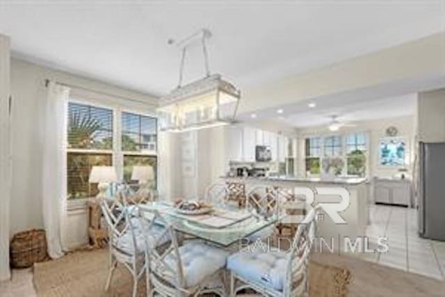 tiled dining room with a healthy amount of sunlight