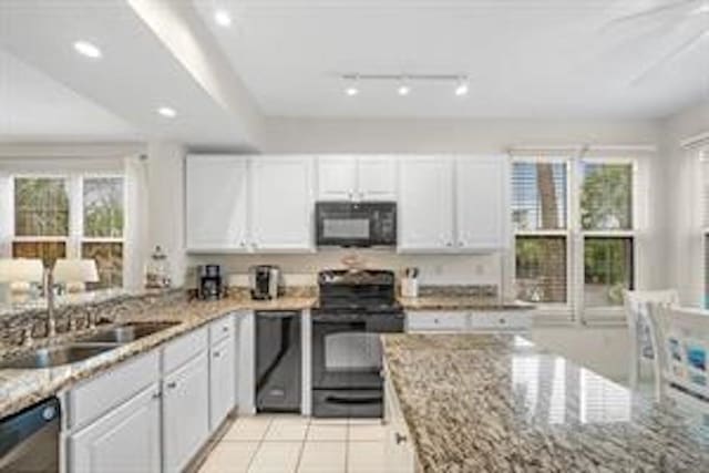 kitchen with range with electric cooktop, light stone counters, and white cabinets