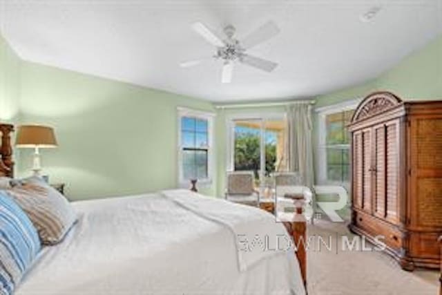 bedroom with ceiling fan and light colored carpet