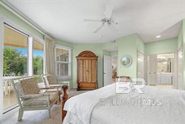 bedroom with ceiling fan and light carpet