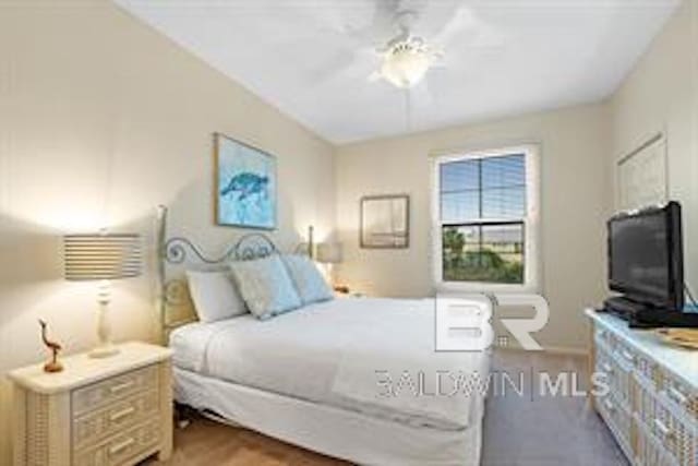 bedroom with hardwood / wood-style floors and ceiling fan