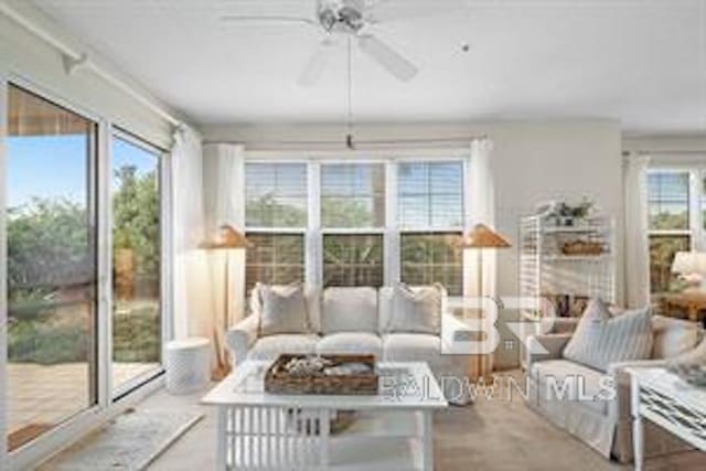 sunroom featuring ceiling fan