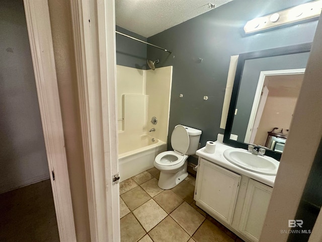 full bathroom featuring a textured ceiling, vanity, bathing tub / shower combination, tile patterned flooring, and toilet