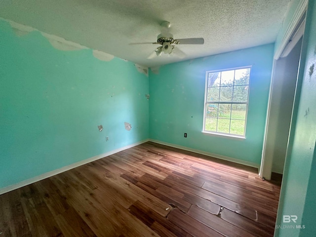 unfurnished room featuring wood-type flooring, a textured ceiling, and ceiling fan