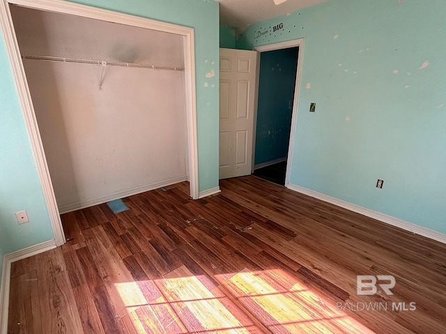 unfurnished bedroom with a closet and wood-type flooring