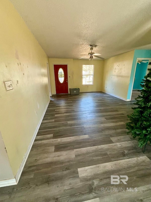 foyer entrance featuring a textured ceiling, ceiling fan, and dark hardwood / wood-style floors