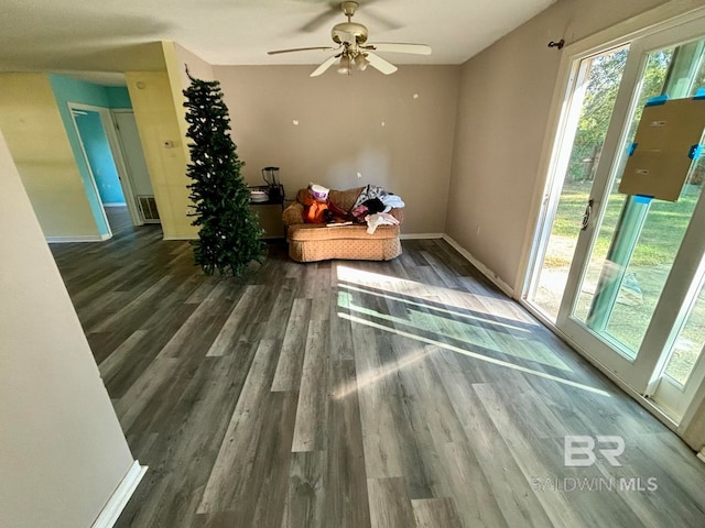 sitting room with ceiling fan and dark hardwood / wood-style floors