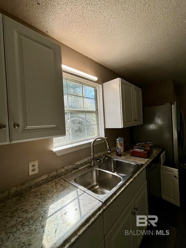 kitchen with sink and a textured ceiling