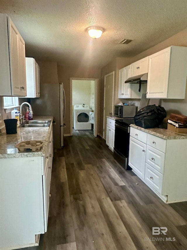 kitchen featuring dark wood-type flooring, white cabinets, sink, a textured ceiling, and washer / clothes dryer