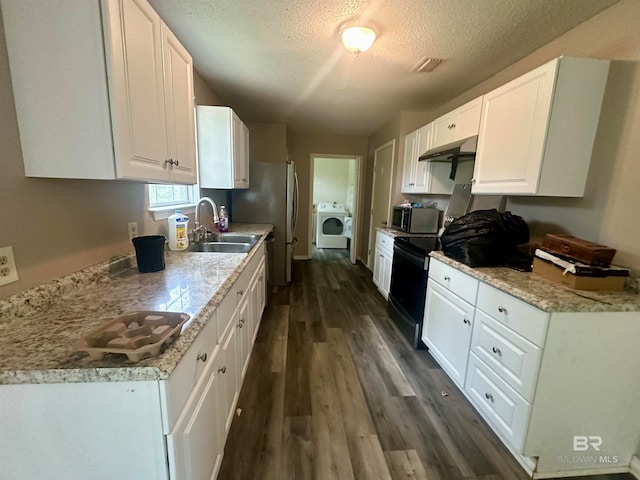 kitchen with white cabinetry, dark hardwood / wood-style flooring, stainless steel appliances, and washer / dryer