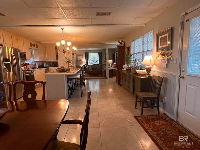 dining space with sink and an inviting chandelier