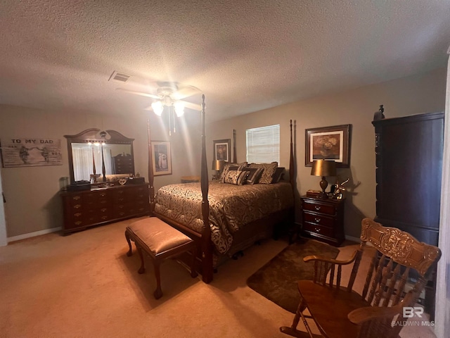 bedroom with carpet, a textured ceiling, and ceiling fan