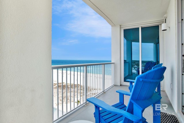 balcony with view of water and beach