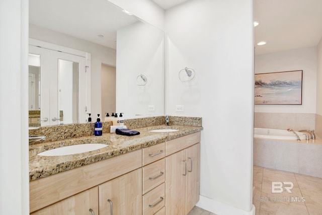 bathroom featuring double vanity, tile patterned flooring, a garden tub, and recessed lighting