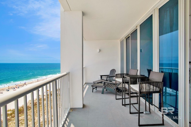 balcony with view of water and beach