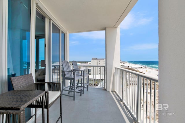 balcony featuring view of water and beach