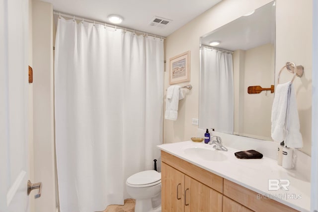 bathroom featuring toilet and vanity