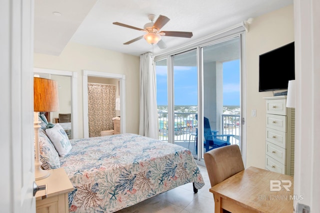 tiled bedroom with access to exterior, a ceiling fan, and ensuite bath
