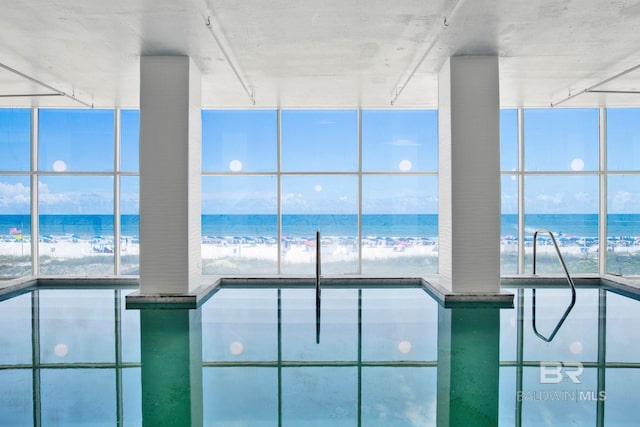 indoor pool with view of water and beach