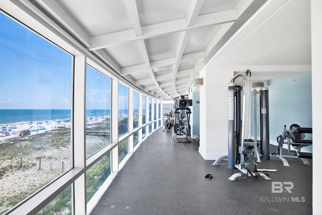 exercise room featuring a water view, healthy amount of natural light, beam ceiling, and coffered ceiling