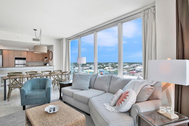 living room featuring healthy amount of natural light, floor to ceiling windows, and a city view