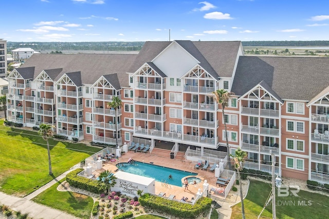 view of building exterior with a community pool