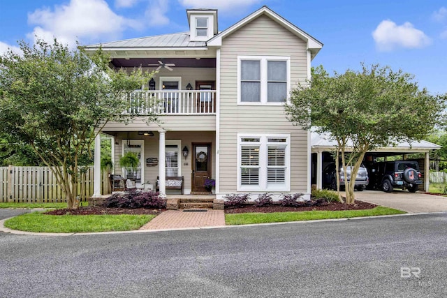 view of front facade with a carport, a balcony, and covered porch