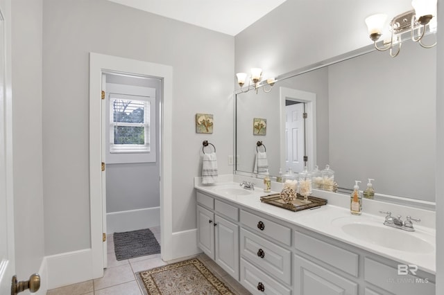 bathroom featuring tile patterned flooring, vanity, and a notable chandelier