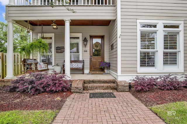 property entrance with a balcony and covered porch