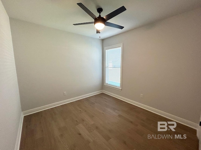 empty room featuring ceiling fan and dark hardwood / wood-style floors