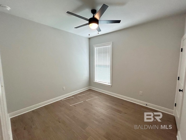 spare room featuring ceiling fan and dark hardwood / wood-style flooring