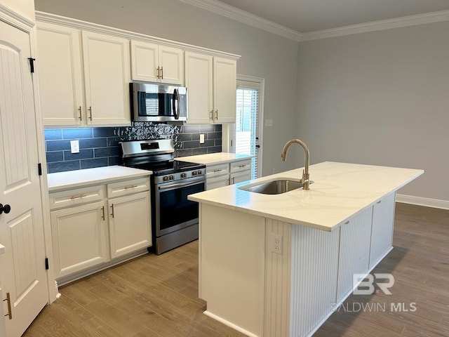 kitchen featuring sink, an island with sink, stainless steel appliances, white cabinets, and light hardwood / wood-style flooring