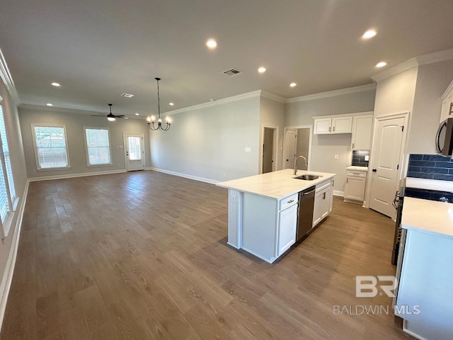 kitchen with an island with sink, white cabinetry, light wood-type flooring, stainless steel appliances, and sink