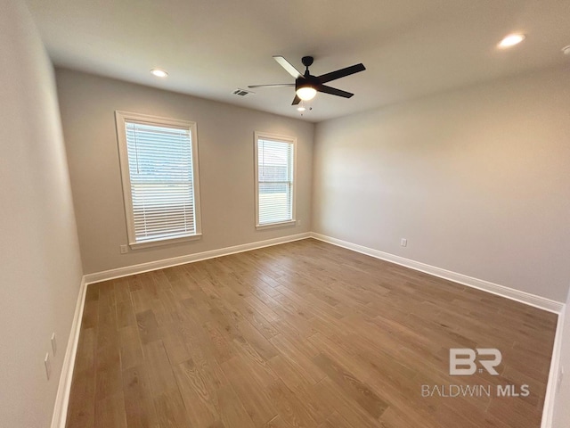 unfurnished room with hardwood / wood-style floors and ceiling fan