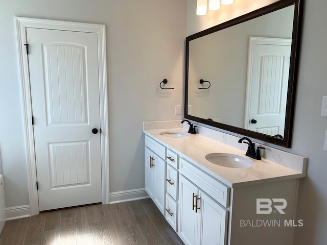 bathroom with vanity and wood-type flooring