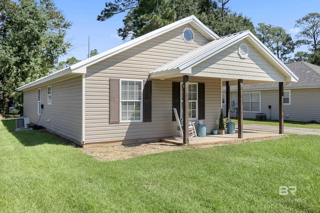 bungalow-style home with a front yard, cooling unit, and covered porch