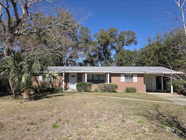 ranch-style home featuring a carport, brick siding, driveway, and a front lawn