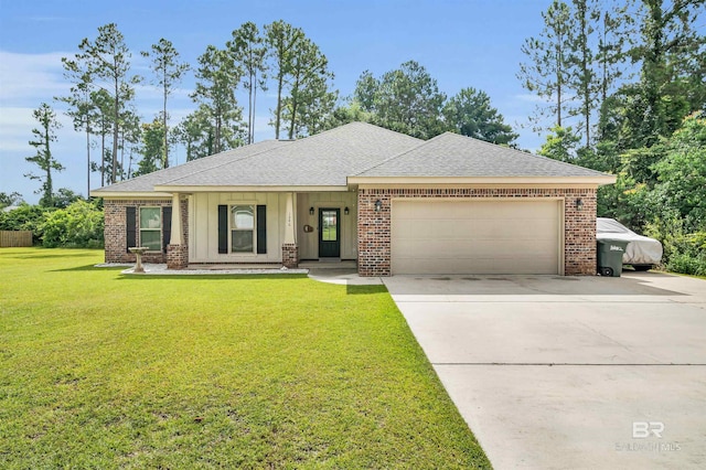 1246 Pembroke Way, Foley, AL 36535 - view of front of house featuring an attached garage, roof with shingles, brick siding, a front lawn, and driveway