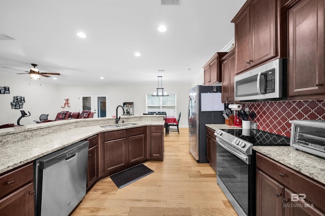 1246 Pembroke Way, Foley, AL 36535 - kitchen featuring appliances with stainless steel finishes, light wood-type flooring, ceiling fan, decorative backsplash, and recessed lighting
