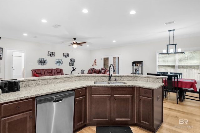 1246 Pembroke Way, Foley, AL 36535 - kitchen featuring stainless steel dishwasher, ceiling fan, open floor plan, light wood-style floors, and light stone countertops