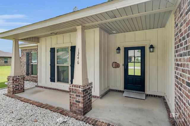 1246 Pembroke Way, Foley, AL 36535 - entrance to property featuring board and batten siding, brick siding, and covered porch