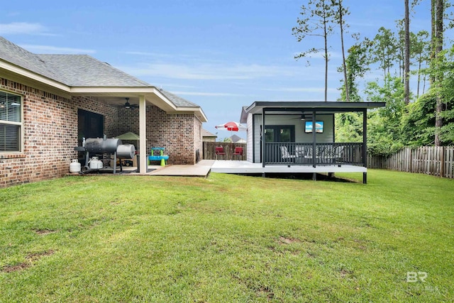 1246 Pembroke Way, Foley, AL 36535 - fenced backyard featuring a ceiling fan, a wooden deck, and a patio area