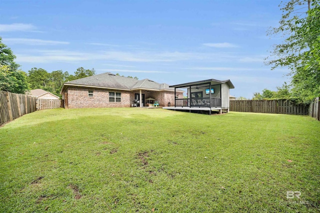 1246 Pembroke Way, Foley, AL 36535 - rear view of house featuring a fenced backyard, a wooden deck, and brick siding