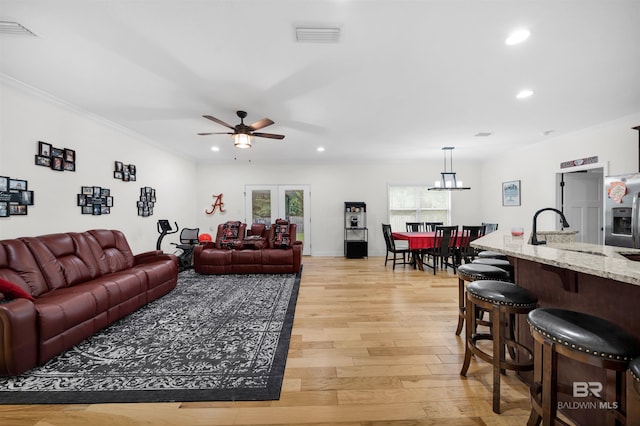1246 Pembroke Way, Foley, AL 36535 - living area featuring recessed lighting, a ceiling fan, light wood-style floors, crown molding, and a chandelier