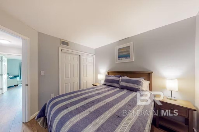 bedroom with a closet and light hardwood / wood-style flooring