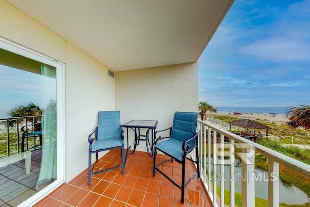 balcony with a view of the beach and a water view