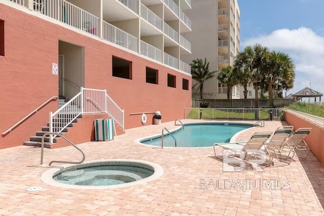 view of swimming pool with a patio and a community hot tub