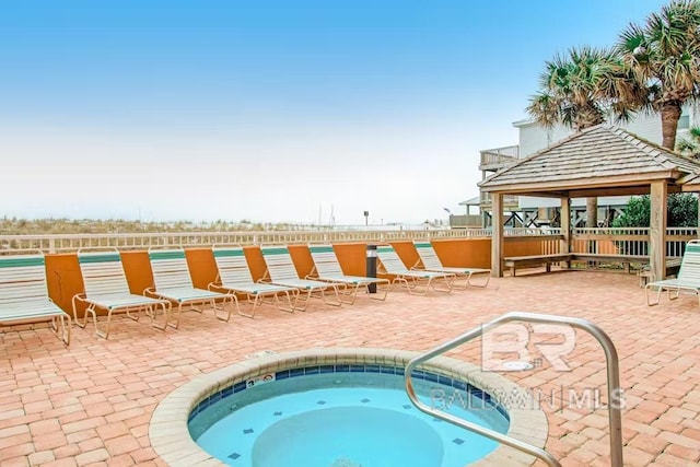 view of swimming pool featuring a gazebo and a hot tub