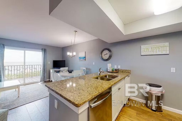 kitchen featuring white cabinets, sink, a chandelier, dishwasher, and light hardwood / wood-style floors